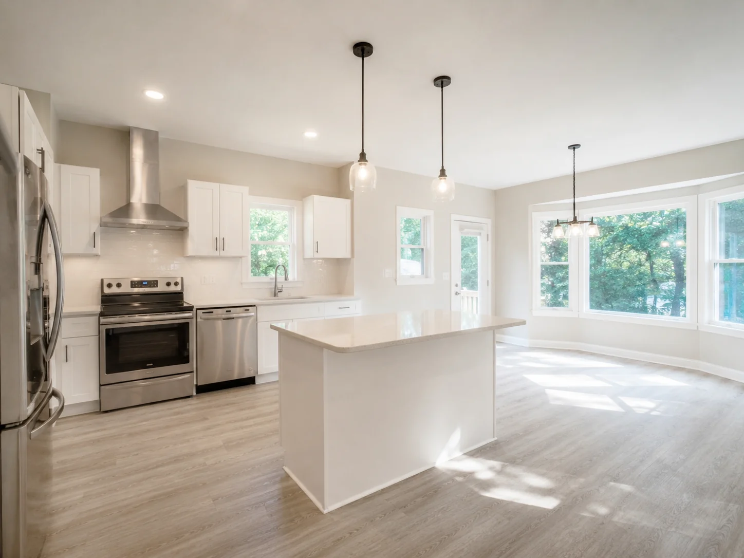 Bright renovated kitchen with an island, pendant lighting, and large windows