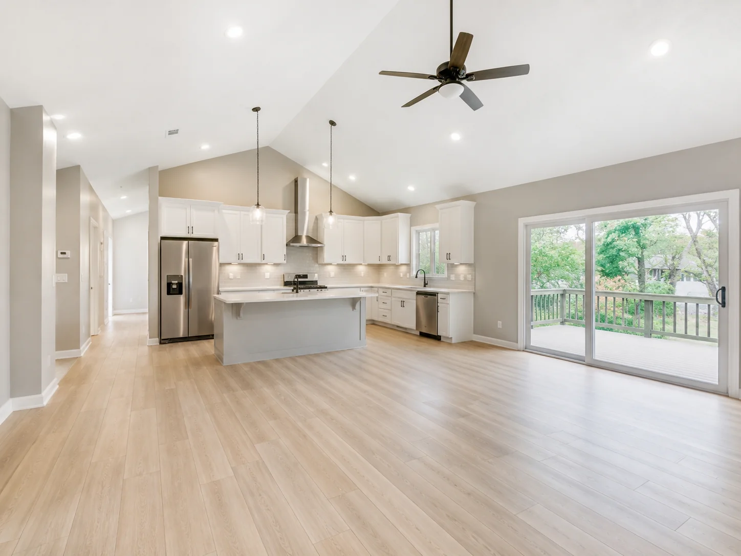 Open-concept renovated kitchen and living area with a vaulted ceiling